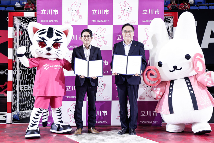 黒田真一社長と市長とマスコットの集合写真(左からジスター、黒田真一社長、市長、くるりん)